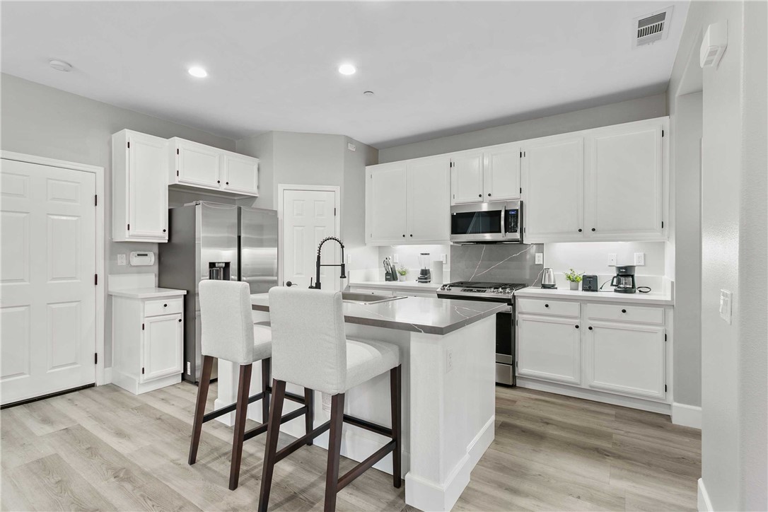 1746 Agrigento Avenue Riverside, CA 92507 - Photo 6 of 22 a kitchen with appliances cabinets and a sink
