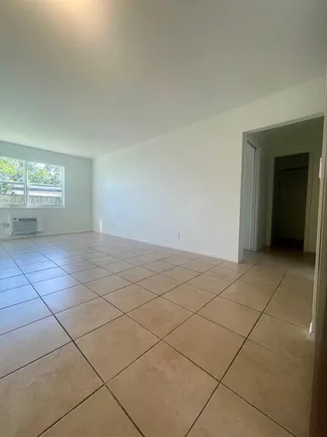 a view of a hallway to rooms