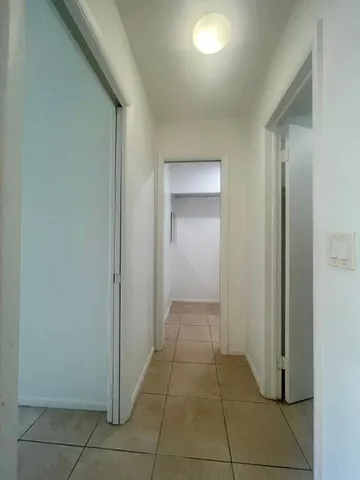 a bathroom with a tub a sink and a large mirror