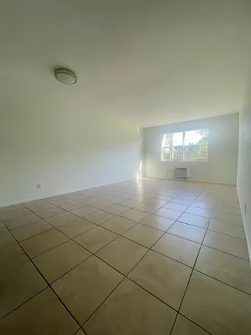 a kitchen with a refrigerator sink and cabinets