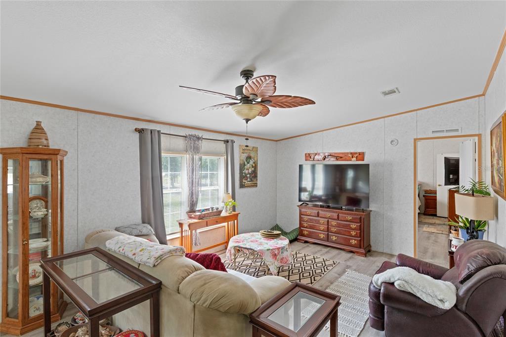 5670 Acadia Street Keystone Heights, FL 32656 - Photo 30 of 65 a living room with furniture a flat screen tv and a window