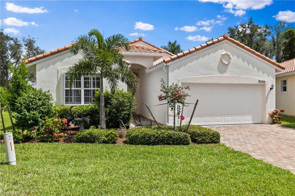 9300 Springview Loop Estero, FL 33928 - Photo 1 of 50 a front view of a house with a yard and garage