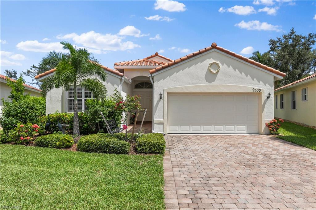 9300 Springview Loop Estero, FL 33928 - Photo 2 of 50 a front view of a house with a yard and garage