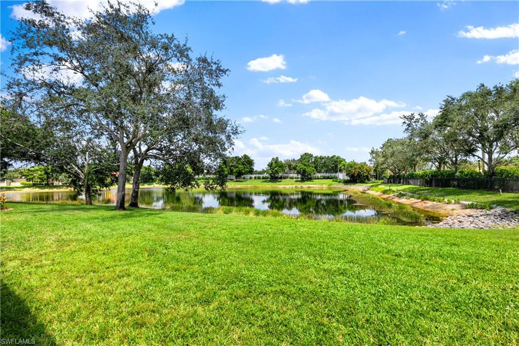 9300 Springview Loop Estero, FL 33928 - Photo 31 of 50 a view of a lake with a house in the background