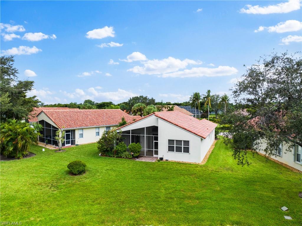 9300 Springview Loop Estero, FL 33928 - Photo 45 of 50 a front view of a house with garden