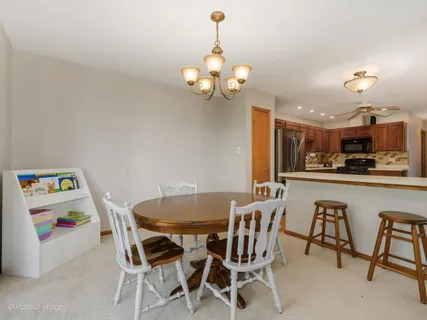 a view of a dining room with furniture and chandelier