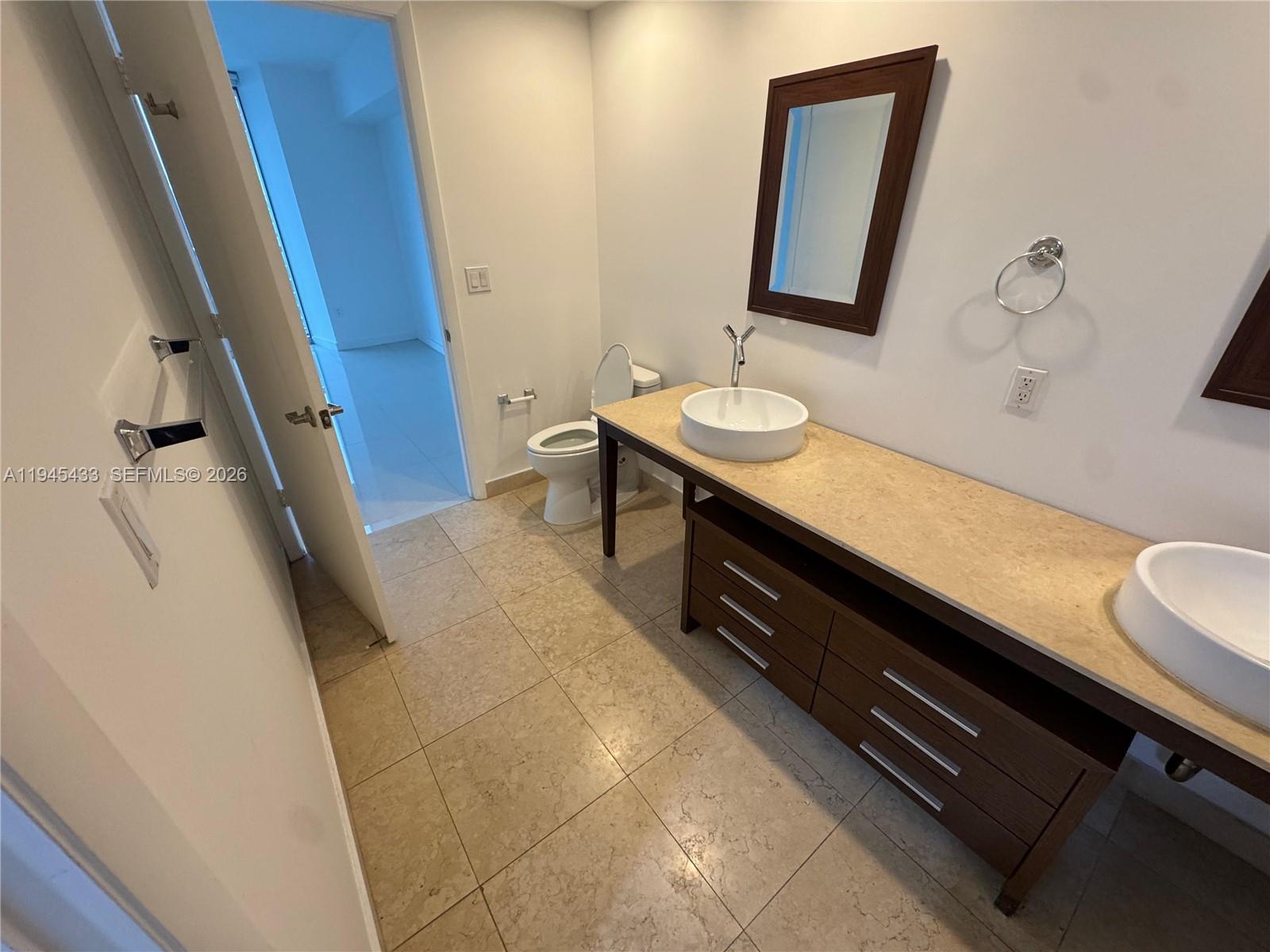 475 Brickell Avenue, Unit 4512 Miami, FL 33131 - Photo 15 of 32 a bathroom with a sink a vanity and a mirror