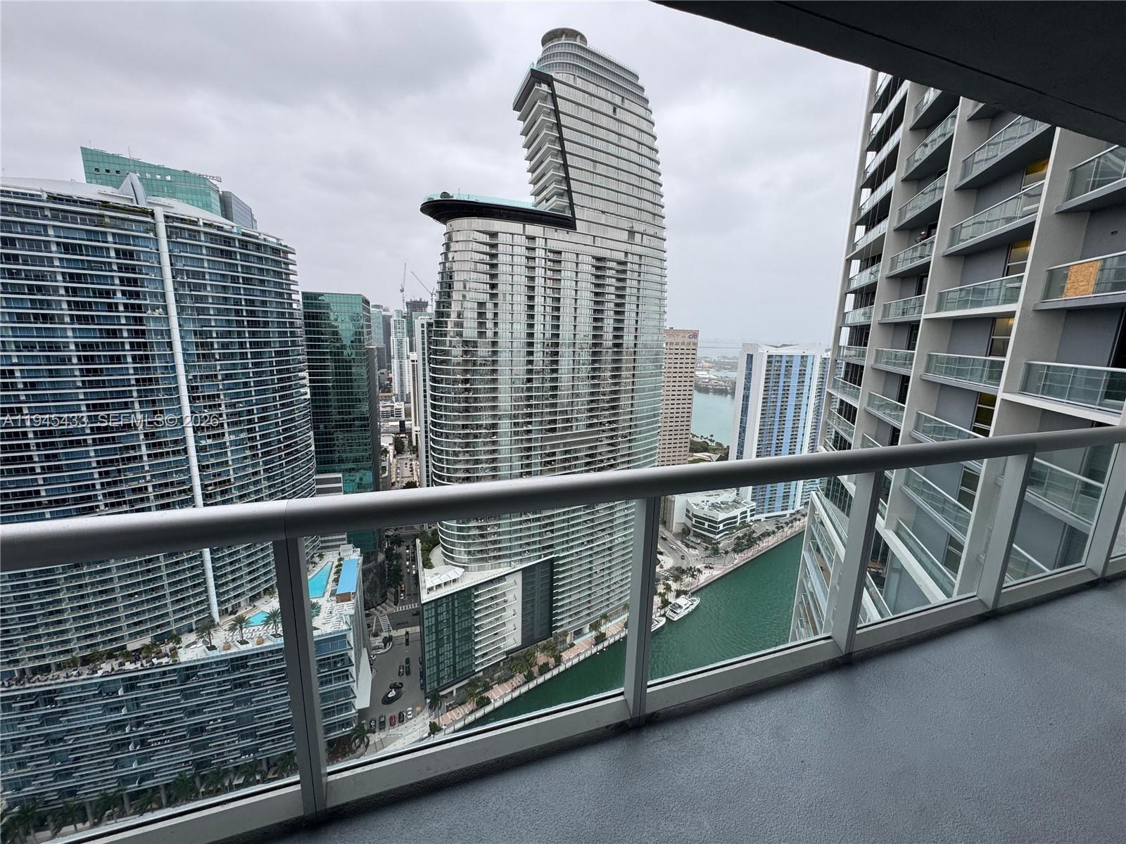 475 Brickell Avenue, Unit 4512 Miami, FL 33131 - Photo 24 of 32 a view of a balcony with wooden floor and fence
