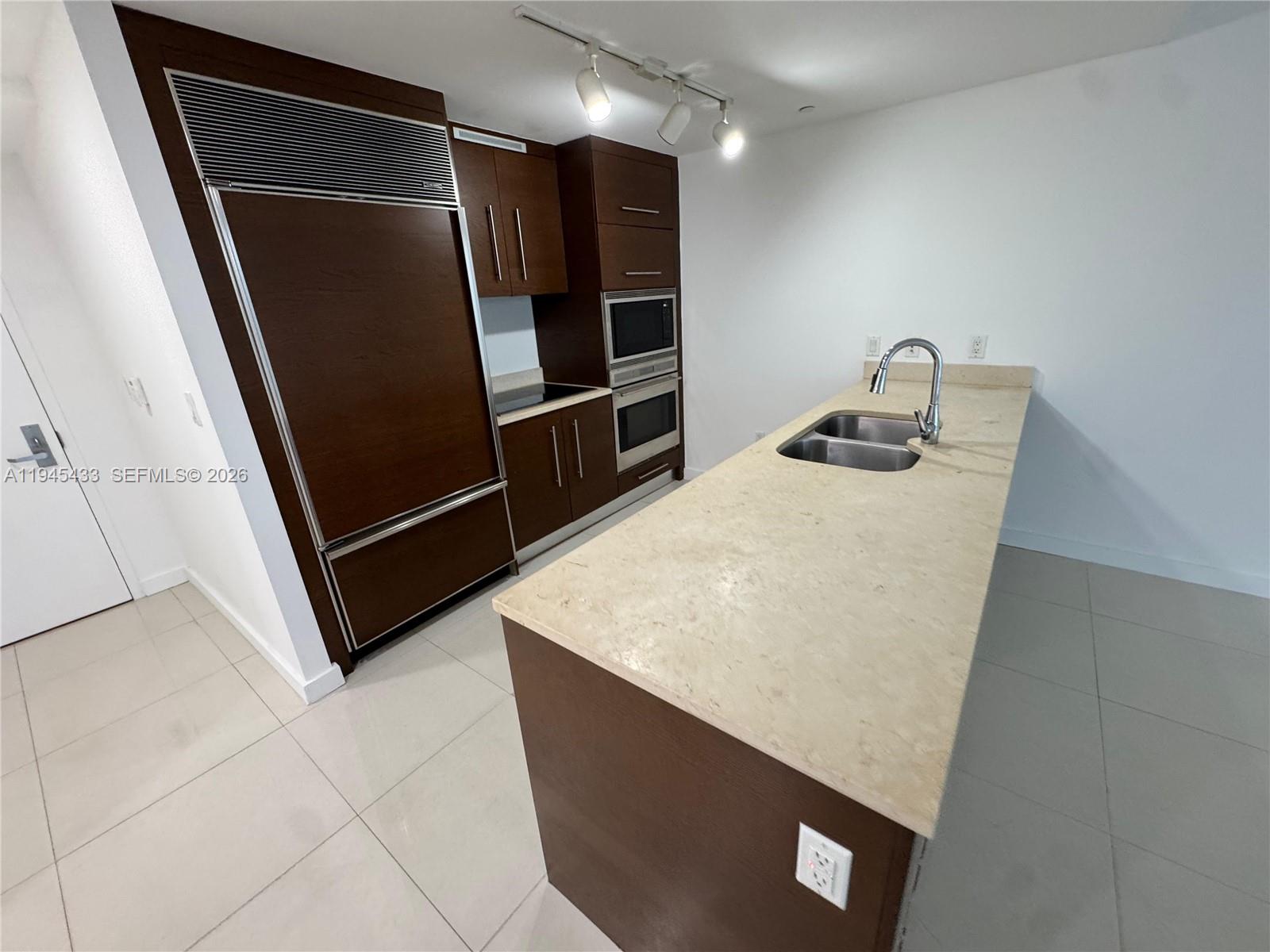 475 Brickell Avenue, Unit 4512 Miami, FL 33131 - Photo 9 of 32 a kitchen with stainless steel appliances a refrigerator and a sink