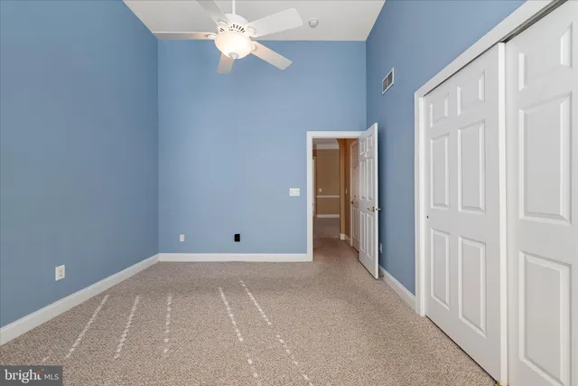 a view of empty room with wooden ceiling