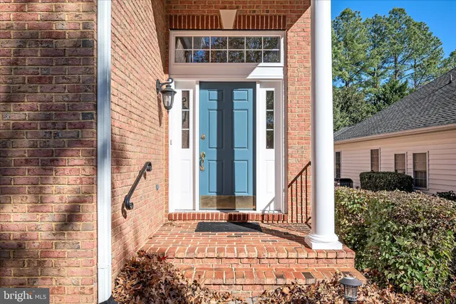 a view of a brick house with large windows