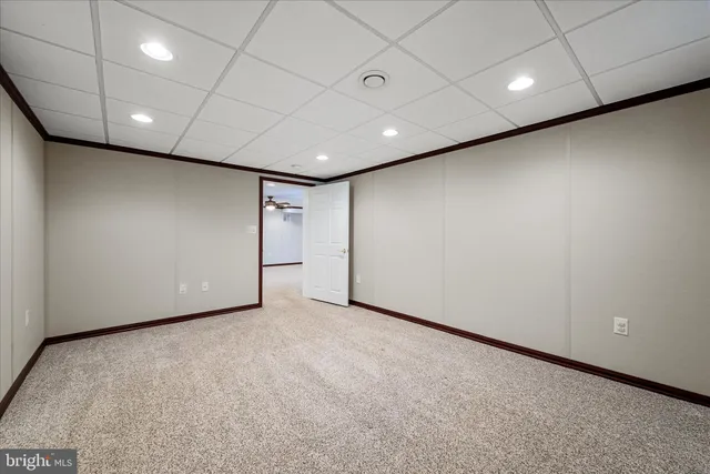 an aerial view of a house with a yard and lake view