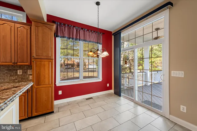 a kitchen with refrigerator and cabinets