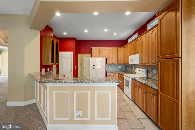 a kitchen with stainless steel appliances granite countertop a refrigerator sink and cabinets
