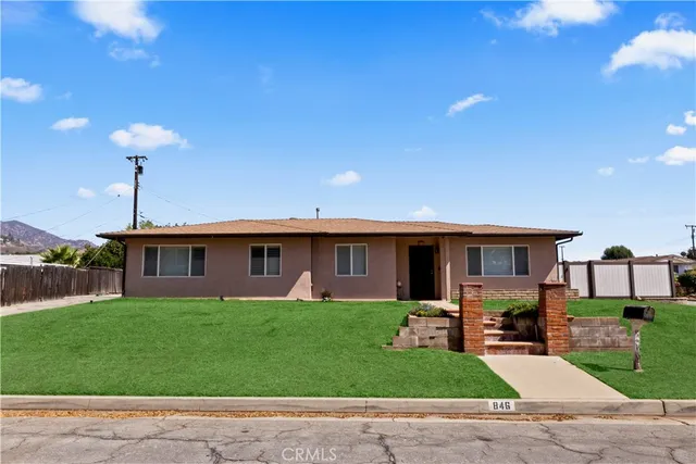 a front view of house with yard and glass windows