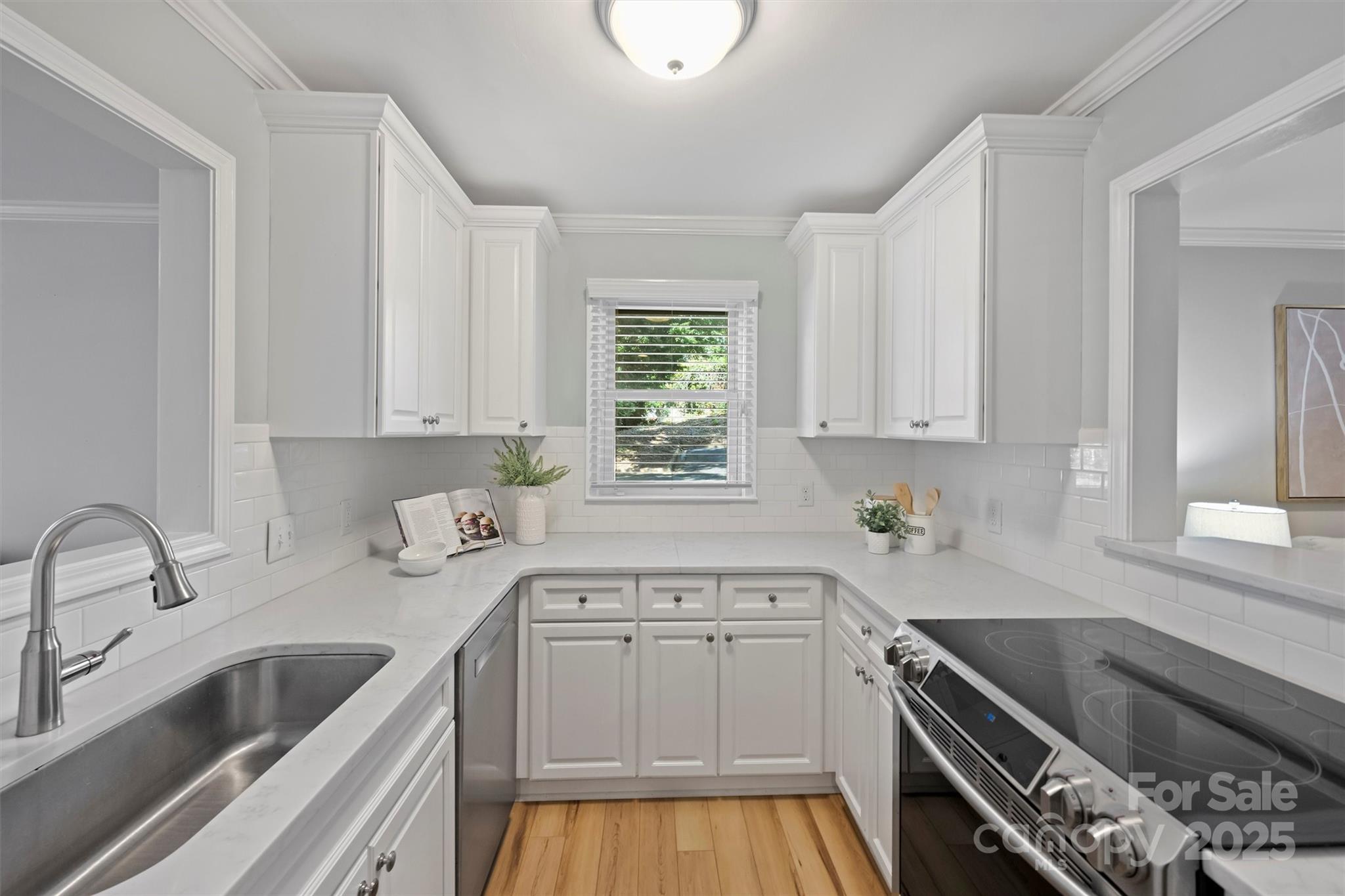 430 Queens Road, Unit 712 Charlotte, NC 28204 - Photo 11 of 43 a kitchen with granite countertop a sink a stove and cabinets