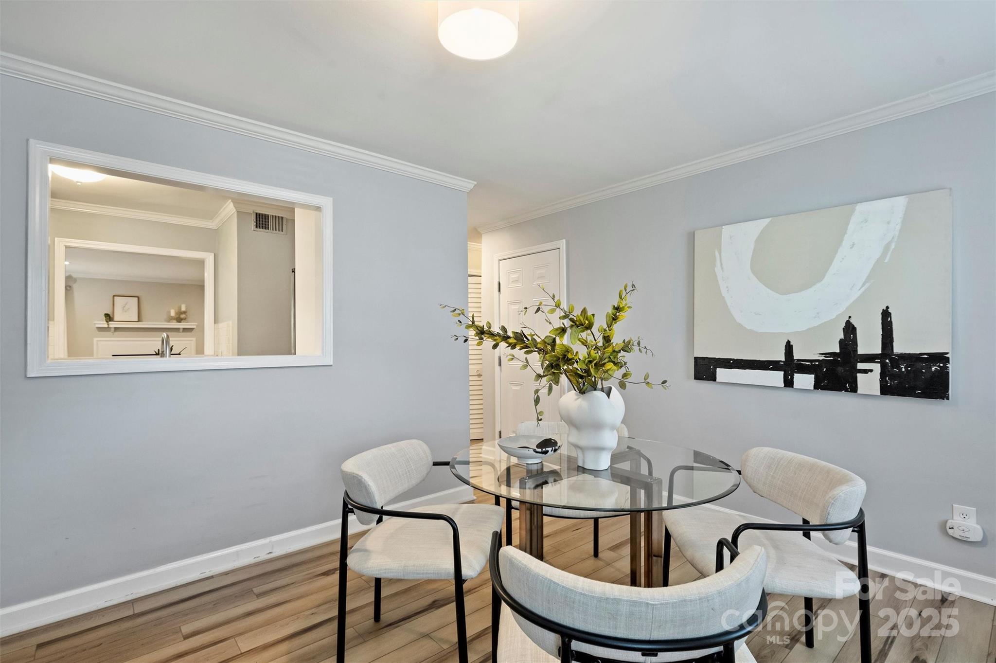 430 Queens Road, Unit 712 Charlotte, NC 28204 - Photo 20 of 43 a dining room with furniture and wooden floor