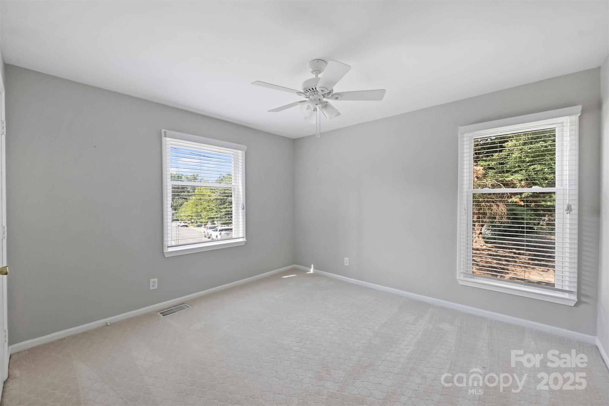 430 Queens Road, Unit 712 Charlotte, NC 28204 - Photo 35 of 43 an empty room with windows and fan