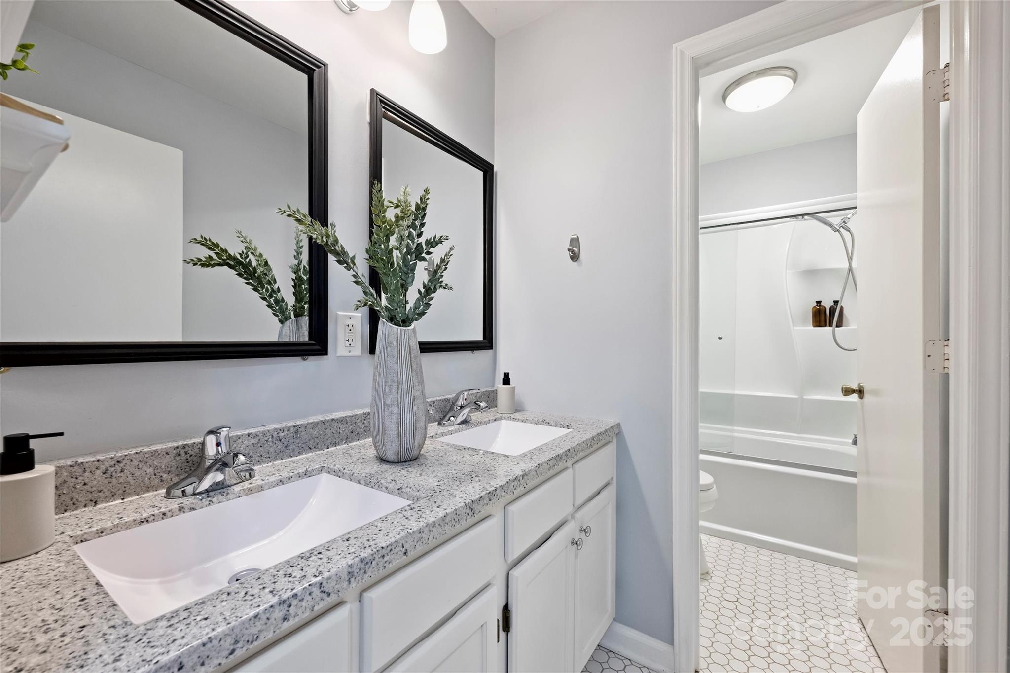 430 Queens Road, Unit 712 Charlotte, NC 28204 - Photo 37 of 43 a bathroom with a granite countertop sink and a mirror