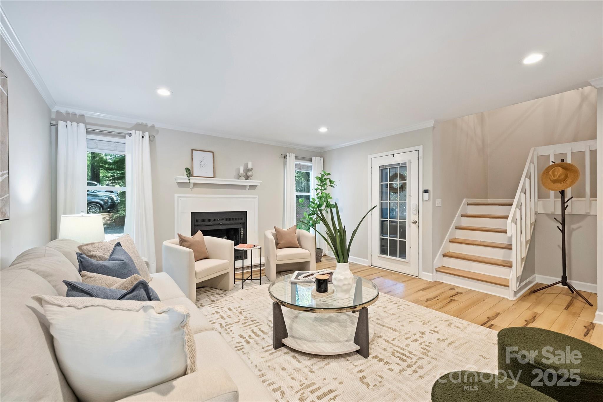 430 Queens Road, Unit 712 Charlotte, NC 28204 - Photo 8 of 43 a living room with furniture and a fireplace