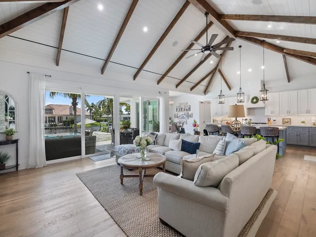 a living room with furniture and a view of kitchen