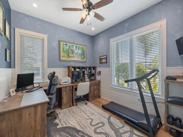 a view of a workspace with furniture and a window