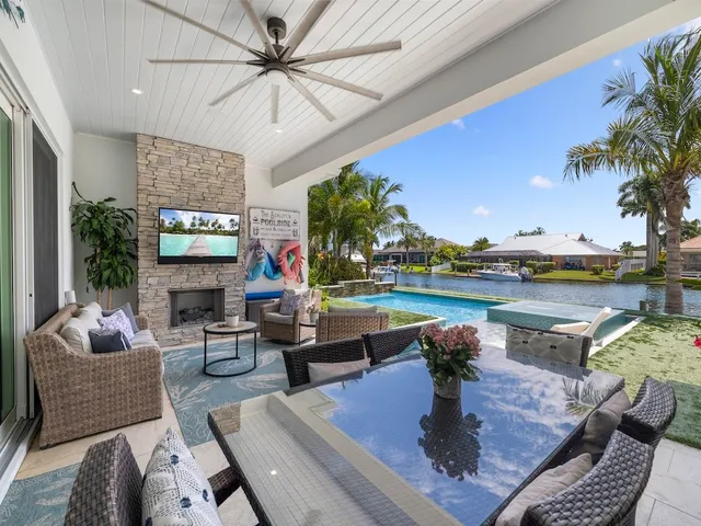 a living room with fireplace furniture and a floor to ceiling window