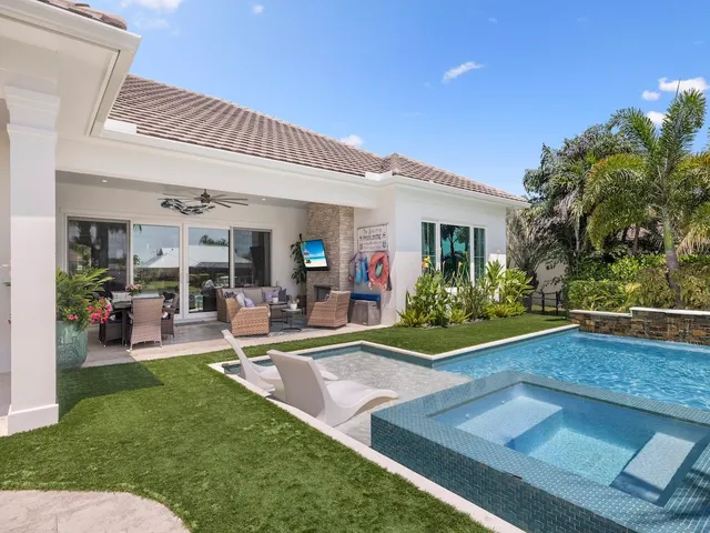 a view of a house with backyard porch and sitting area