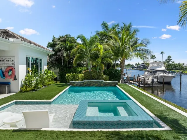 a view of a backyard with swimming pool