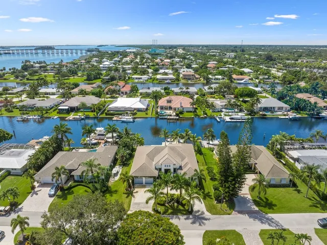 an aerial view of residential houses with outdoor space and river