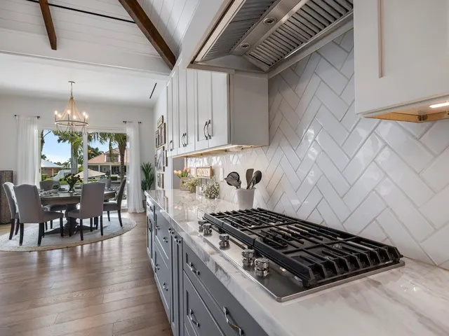 a stove top oven sitting inside of a kitchen