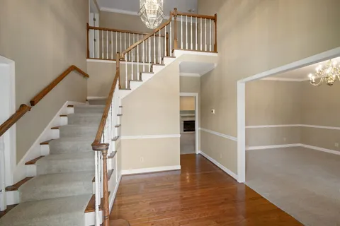 a view of entryway and hall with wooden floor