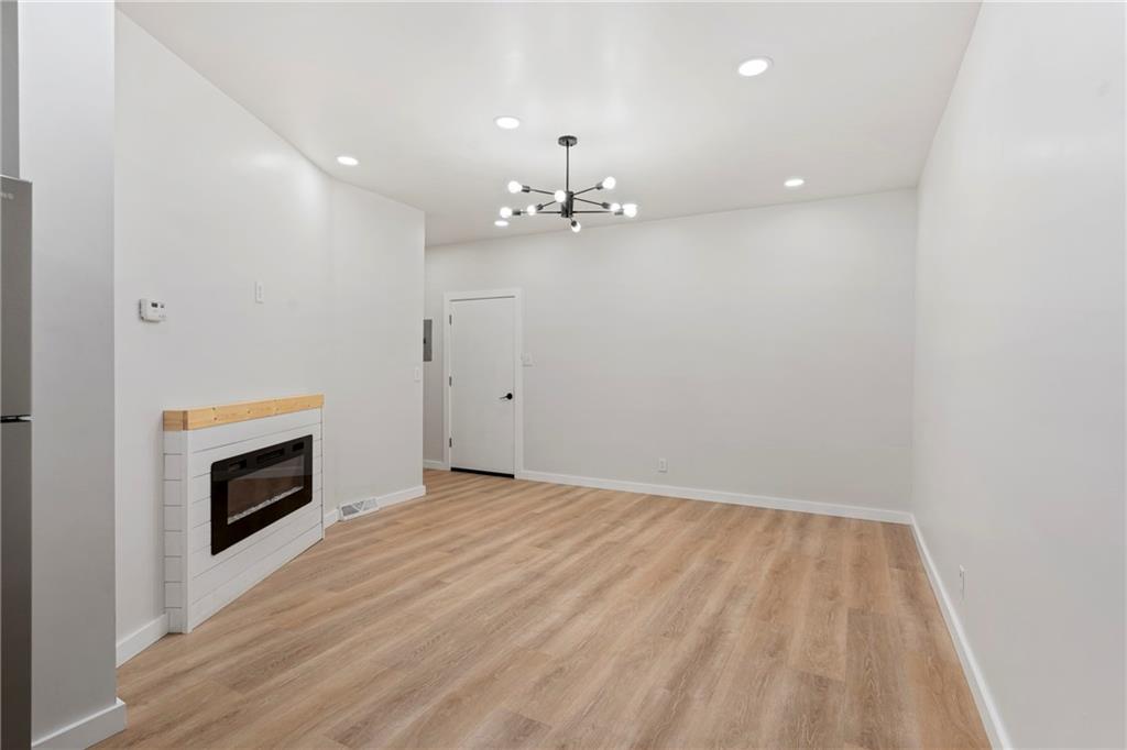 5140 Butler Street Pittsburgh, PA 15201 - Photo 6 of 25 wooden floor in an empty room with a fireplace