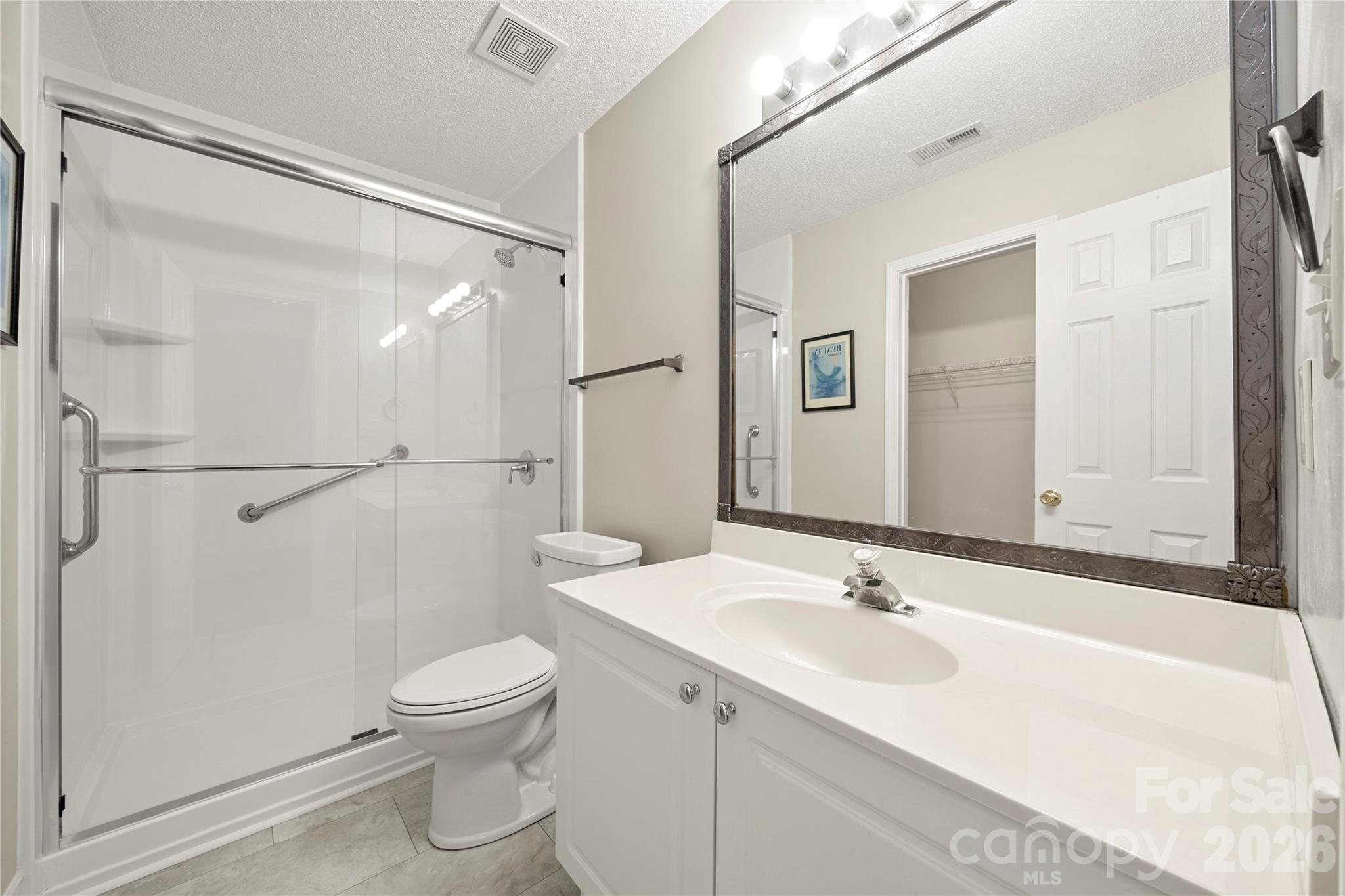461 Lexie Lane Rock Hill, SC 29732 - Photo 10 of 20 a bathroom with a sink a toilet and a large mirror