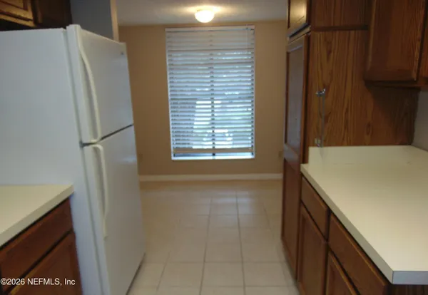 a view of walk in closet with window and refrigerator