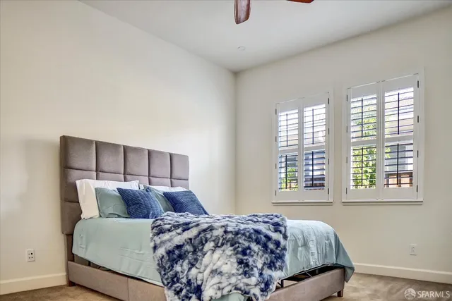 a bed sitting in a bedroom next to a window