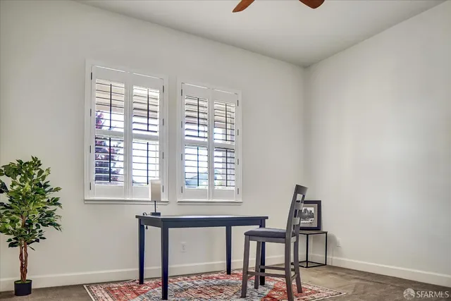 a view of a room with a window and wooden floor