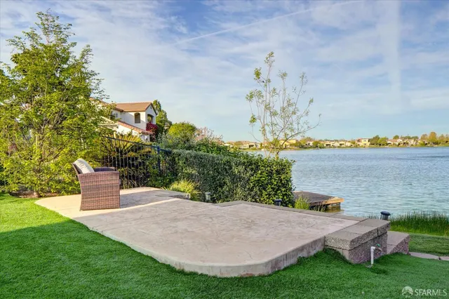 a view of a house with a yard and potted plants