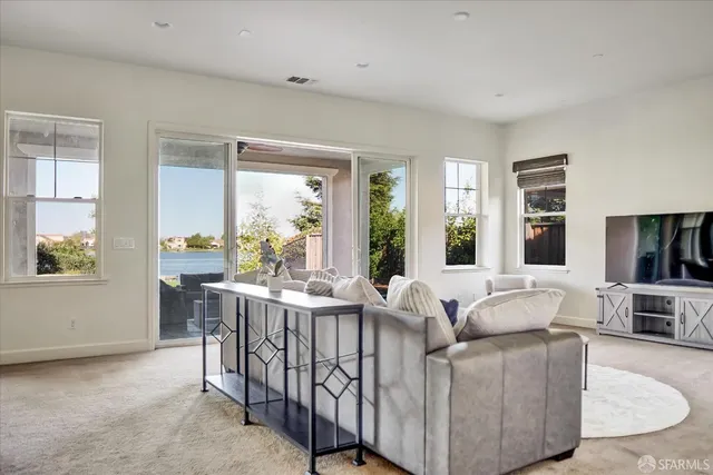 a living room with furniture and large windows