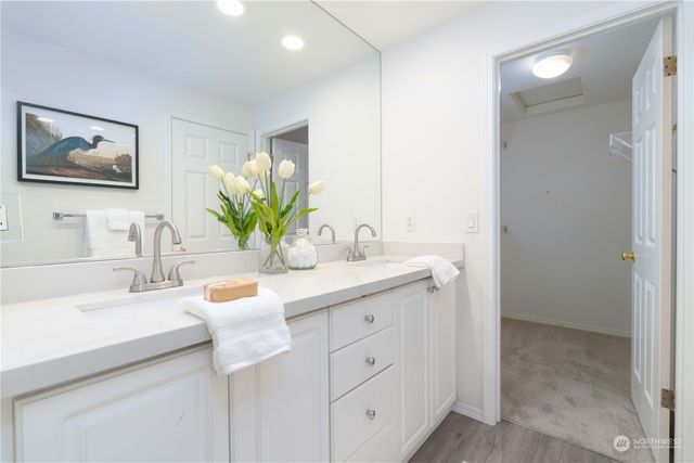 a bathroom with a sink a vanity and a mirror
