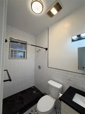 a bathroom with a toilet a sink and shower