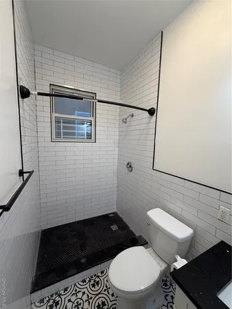 a bathroom with a toilet and a shower