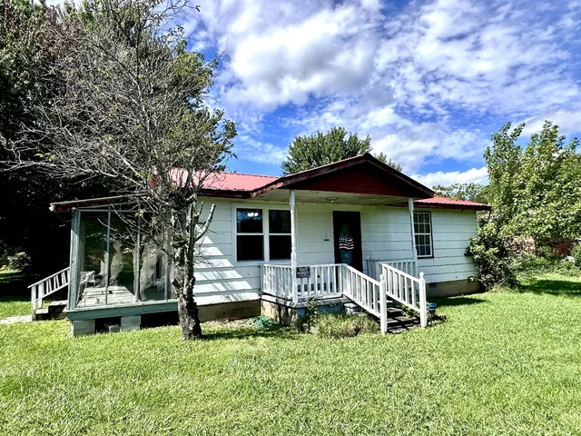 a view of a house with a yard porch and sitting area