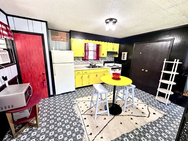 a room with furniture a rug and a flat screen tv