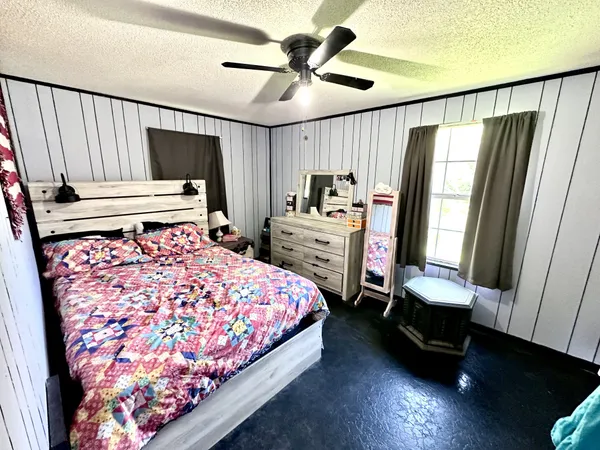 a bedroom with a bed closet and a flat tv screen