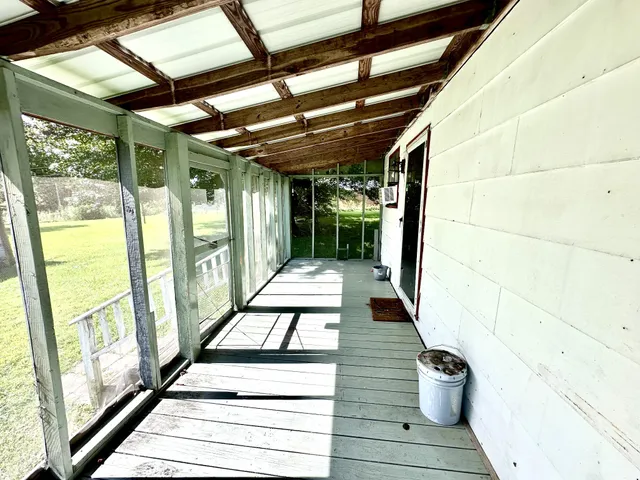 a view of a porch with wooden floor