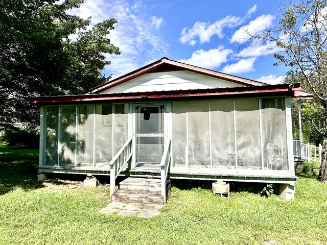 a view of a house with a backyard