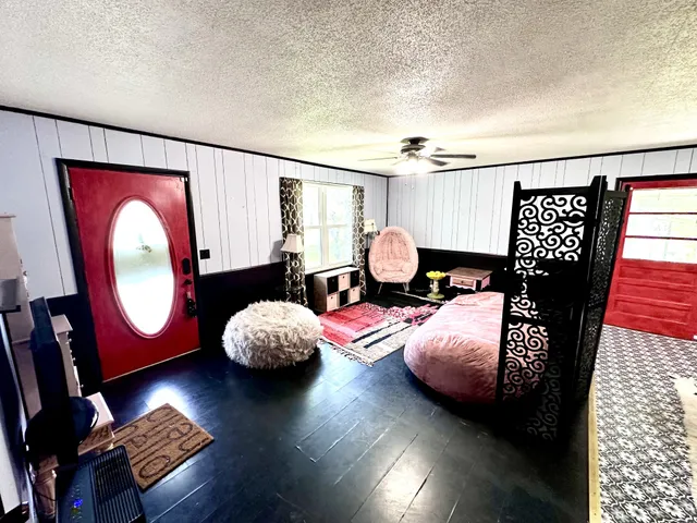 a bedroom with furniture and a wooden floor