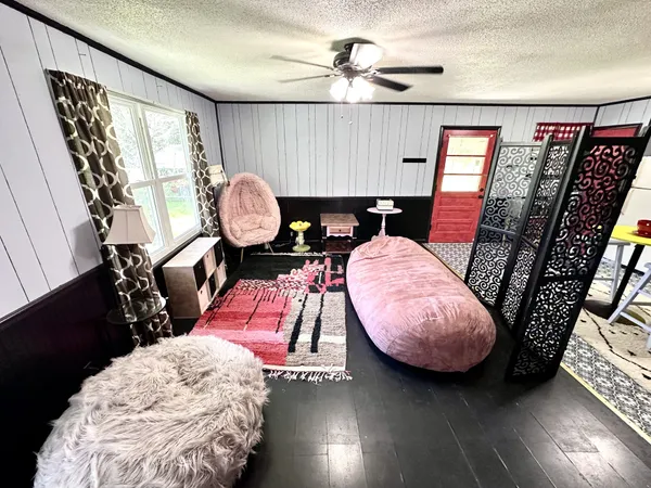 a living room with furniture and wooden floor