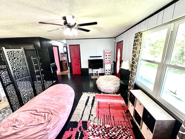 a bedroom with furniture and a window